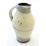 A studio pottery jug with drip and brushwork decoration. Indistinctly signed under. Approx. 11 1/