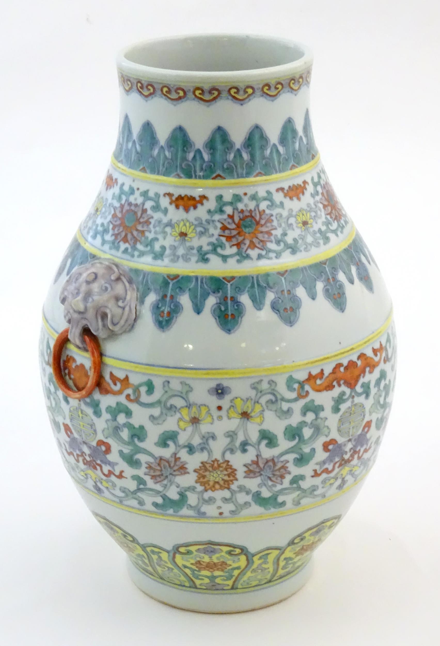 A Chinese famille verte vase with a bulbous body with twin ring mask handles, decorated with - Image 3 of 7