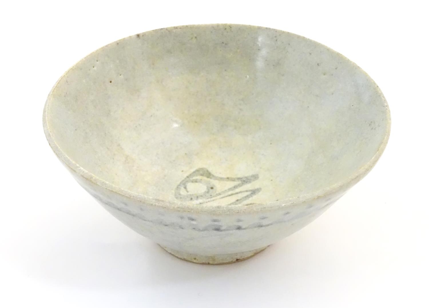 An Oriental earthenware bowl of tapering form with brushwork detail. Approx. 2 1/4" high x 5"