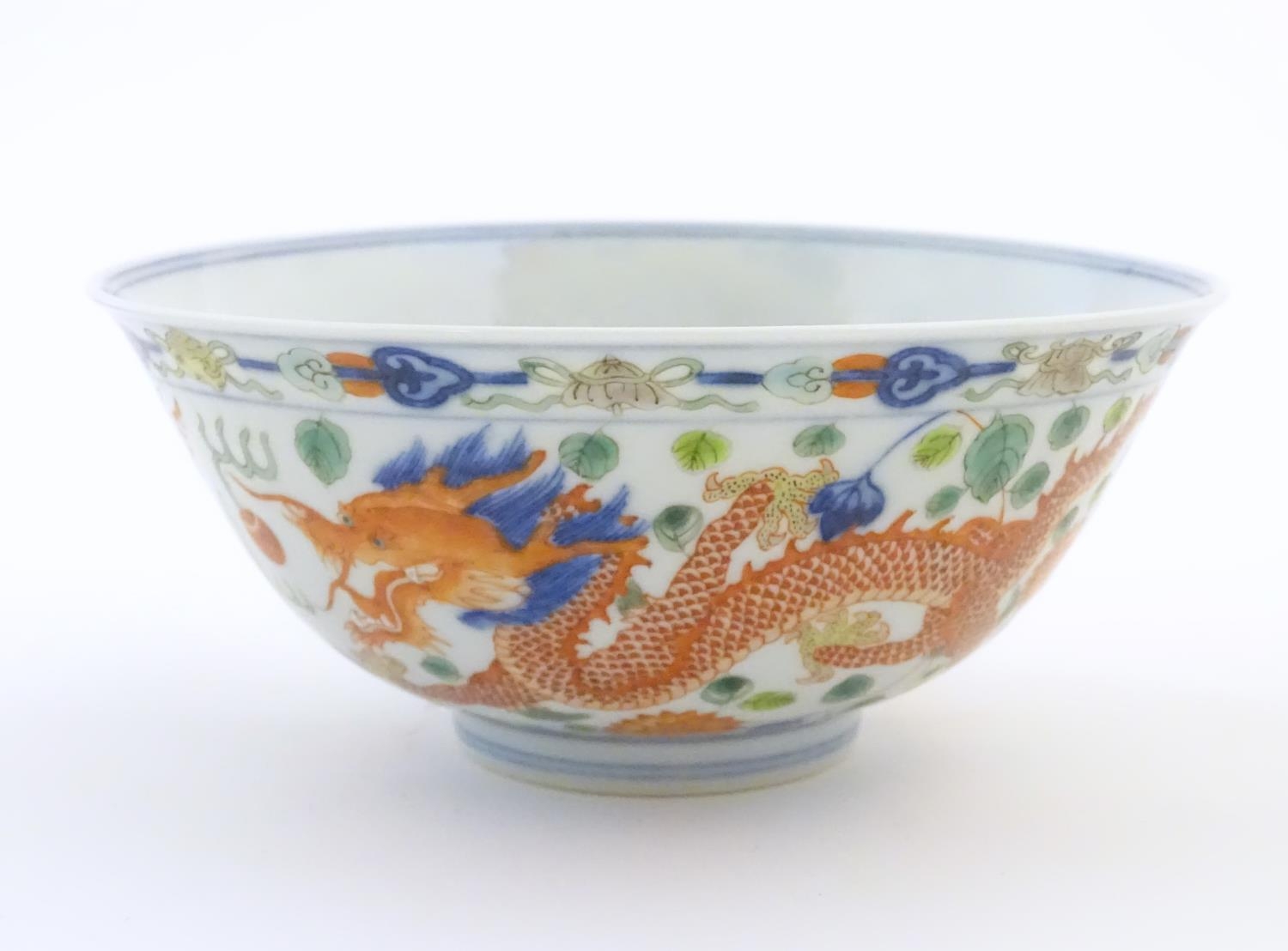 A Chinese bowl with dragon and flaming pearl detail, with flowers, foliate and stylised clouds. - Image 4 of 6