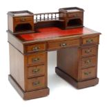 An early 20thC double pedestal mahogany desk with a raised gallery and two short drawers above an