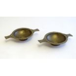 A pair of Scottish brass quaich with Celtic decoration and inset 1943 threepence coin. Approx. 7 3/
