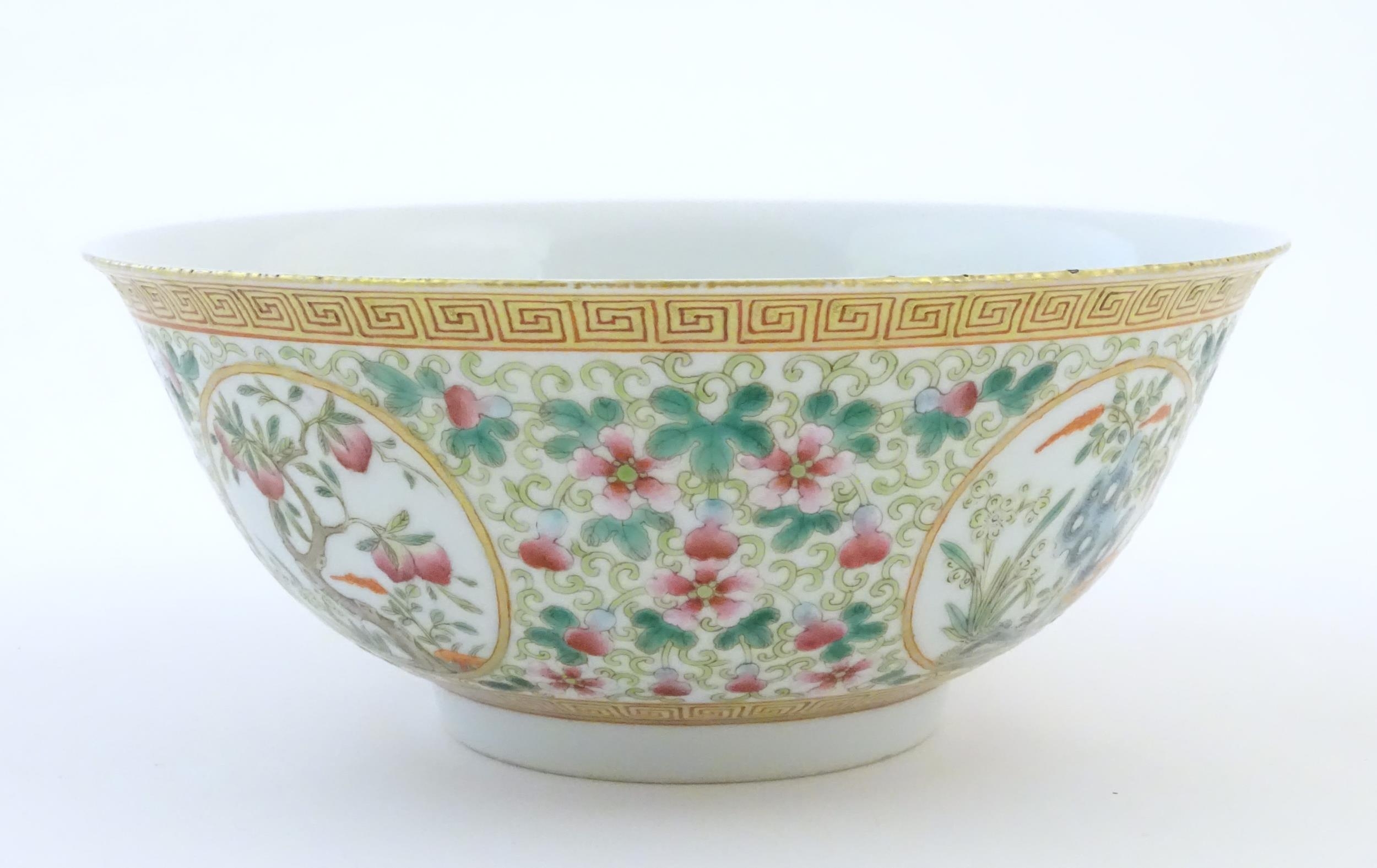 A Chinese famille verte bowl decorated with fruiting trees and landscapes scenes in roundels and - Image 4 of 6