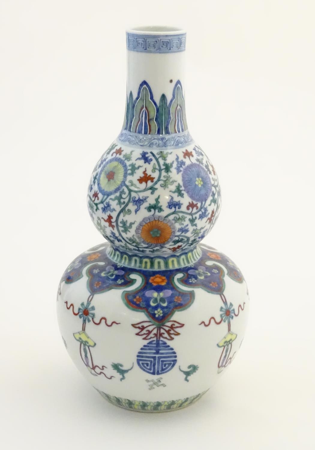 A Chinese double gourd vase with doucai style decoration with scrolling floral and foliate detail. - Image 5 of 16