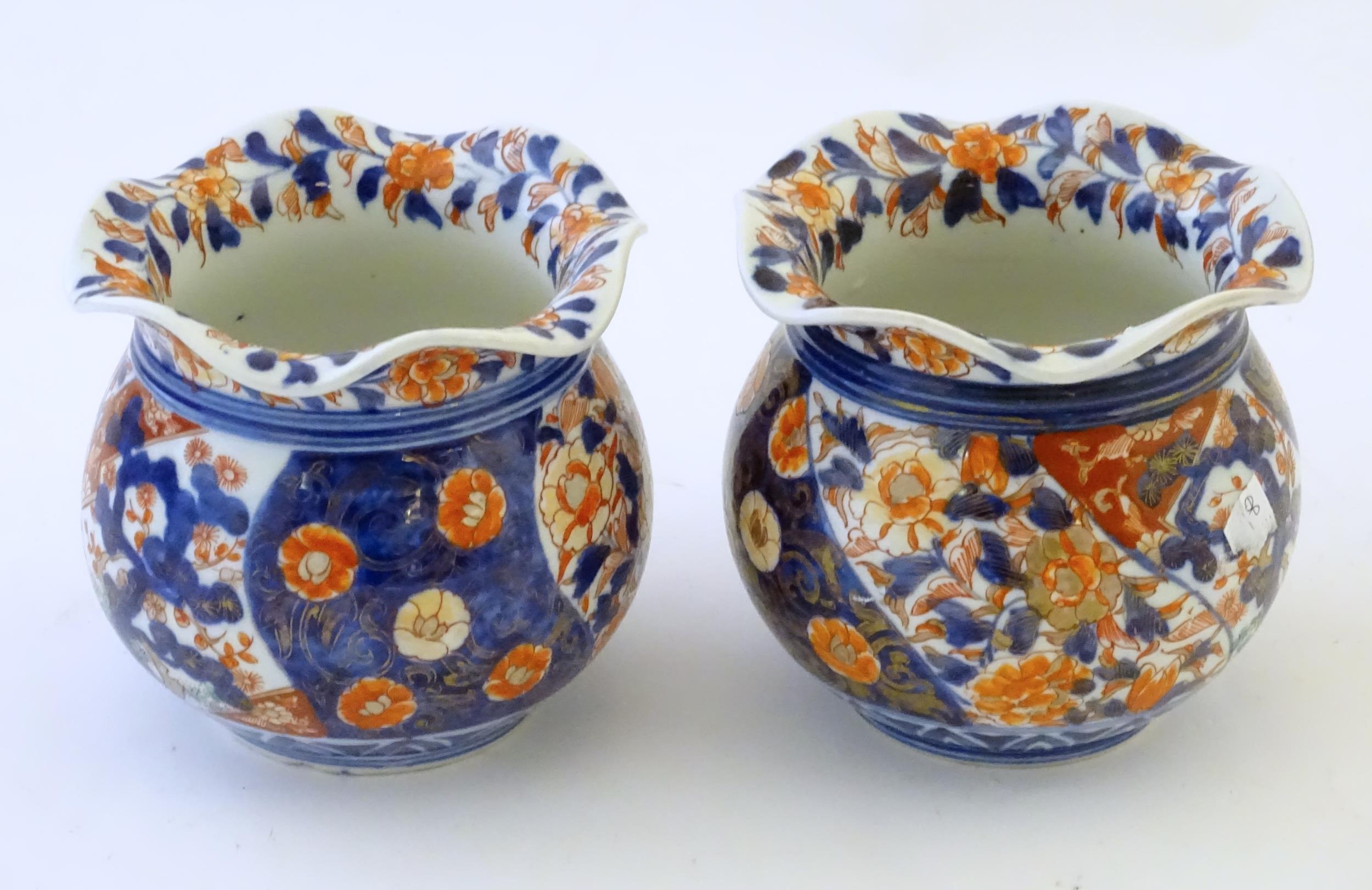 Two Oriental vases of bulbous form with flared rims decorated in the Imari palette with flowers - Image 2 of 8