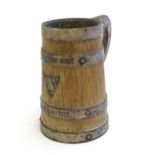 An oak tankard with silver plate handle, banding and shield, engraved Parkside 1907, C F O Master,