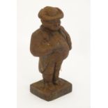 A 19thC cast iron model of a portly gentleman carrying a book, possibly a lawyer. Approx. 5 1/4"