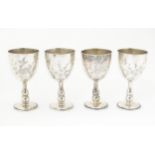 Four Chinese white metal small goblets / egg cups with engraved decoration. Marked with character