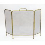 A late 19th/early 20thC brass folding fire screen / spark guard with turned feet. Approx. 25 1/2"