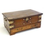 A 19thC Dutch colonial Paduak wood box with pierced decorative brackets and strap work above a small