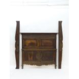 A 19thC carved oak bed with a moulded cornice and carved frieze above inset panels and shaped carved