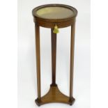A 19thC bijouterie cabinet with a circular glass top above an inlaid checkered frame and having