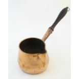 A 19thC copper saucepan with spout and turned wooden handle. Approx. 14 1/4" long Please Note - we