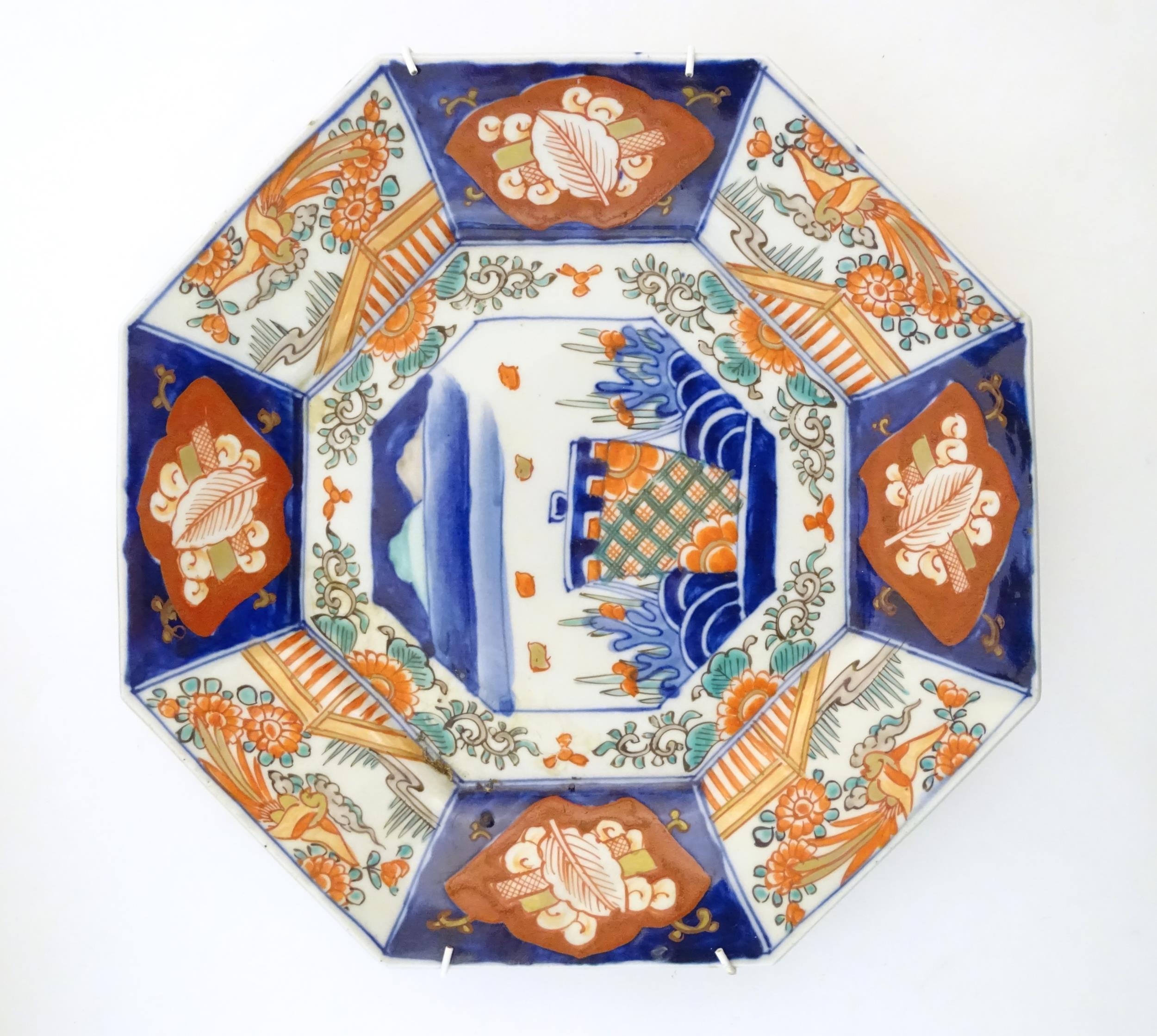 A Japanese octagonal plate in the Imari palette decorated with birds, flowers and foliage, with