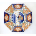 A Japanese octagonal plate in the Imari palette decorated with birds, flowers and foliage, with