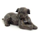 A 20thC cast model of recumbent dog / pug. Approx. 4 3/4" high Please Note - we do not make