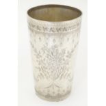 A Victorian silver beaker with engraved decoration, hallmarked London 1875, maker H. J/ Lias &