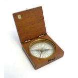 An early 20thC cased travel / pocket compass with a printed paper dial. Dial approx. 1 5/8" diameter