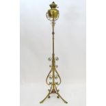 An 1891 Benham & Froud brass and copper tripod standard lamp in the manner of Dr C Dresser.