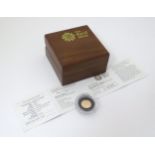 Coin: A Royal Mint 2009 gold proof quarter sovereign, limited edition no 4185. With box and