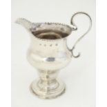 A Geo III silver cream jug, hallmarked London 1780, maker Charles Hougham 4 3/4" high Please