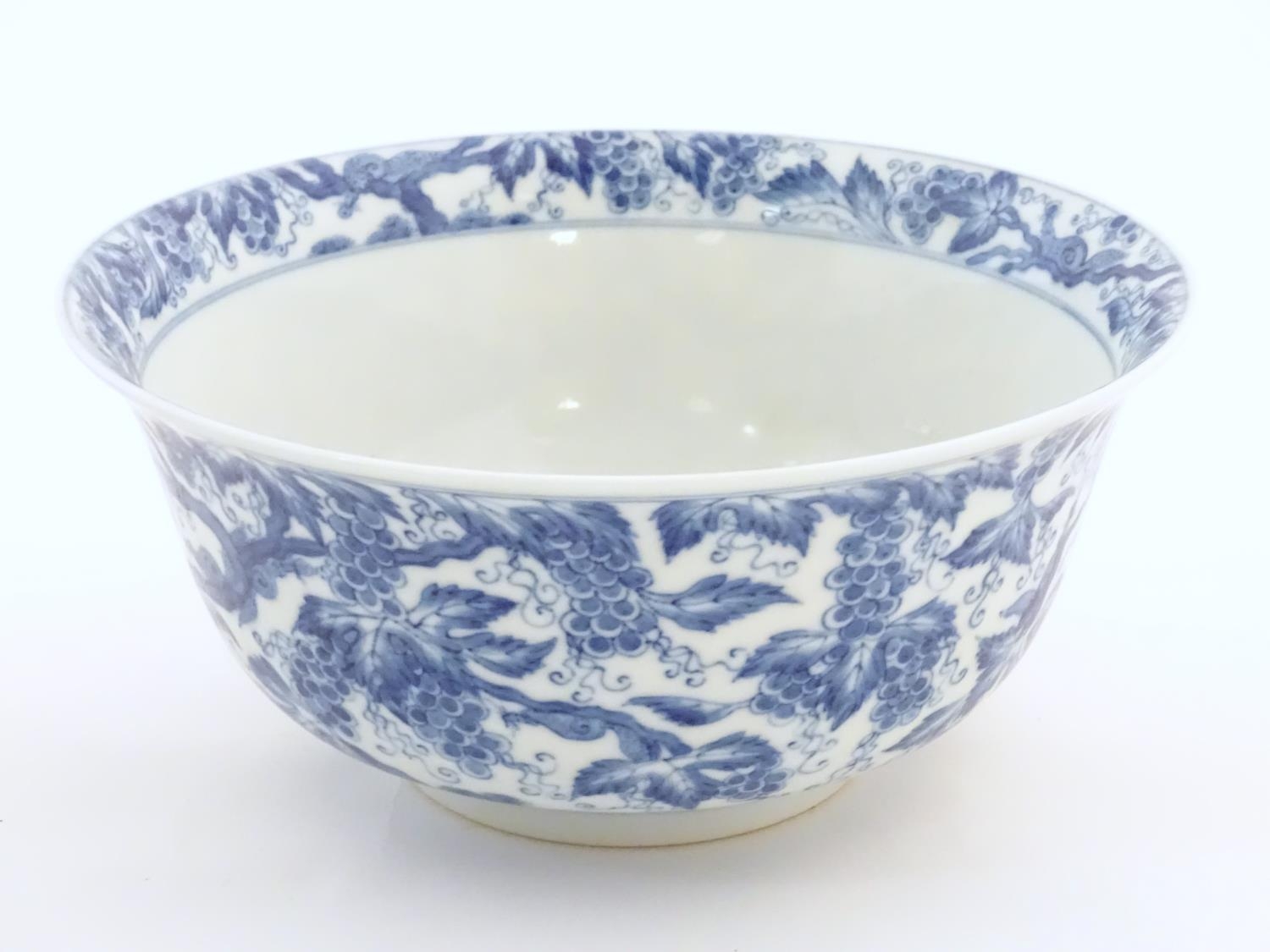 A Chinese blue and white bowl decorated with vine leaves and grapes. Character marks under. - Image 3 of 9