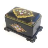 A Victorian lacquered papier mache two sectional tea caddy with shaped feet, decorated with inlaid