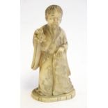 A 19thC Oriental carved ivory figure depicting a gentleman in robes. Approx. 4 1/2" high Please Note