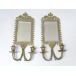 A pair of Victorian twin branch brass girandole with mirrors, the surround surmounted by a flaming