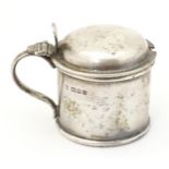 A silver mustard pot with blue glass liner, hallmarked London 1924, maker Edward Barnard & Sons Ltd.