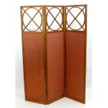 A satinwood three fold screen with inlaid decoration and three glazed panels above fabric