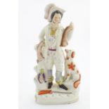 A Staffordshire pottery huntsman with a seated dog, and game birds and hares. Approx. 15" high