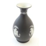 A small Wedgwood Etruria black jasperware vase decorated with classical figures, putti etc.