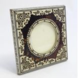 A Victorian Anglo-Indian tortoiseshell and ivory Vizagapatam photograph frame, with penwork floral