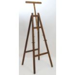 A 20thC large wooden artist's easel, the uprights with holes for the pegs. Birmingham