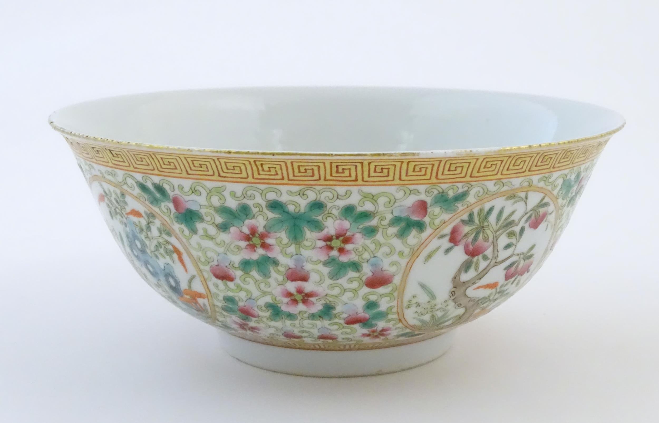 A Chinese famille verte bowl decorated with fruiting trees and landscapes scenes in roundels and - Image 5 of 6