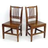 A pair of early 20thC mahogany side chairs with shaped top rails and moulded back splats above