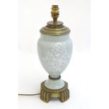 A Victorian table lamp, the celadon coloured porcelain body with Pate sur Pate floral and foliate