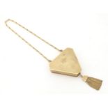 A Victorian 9ct gold compact of triangular form with engine turned decoration, tassel detail and