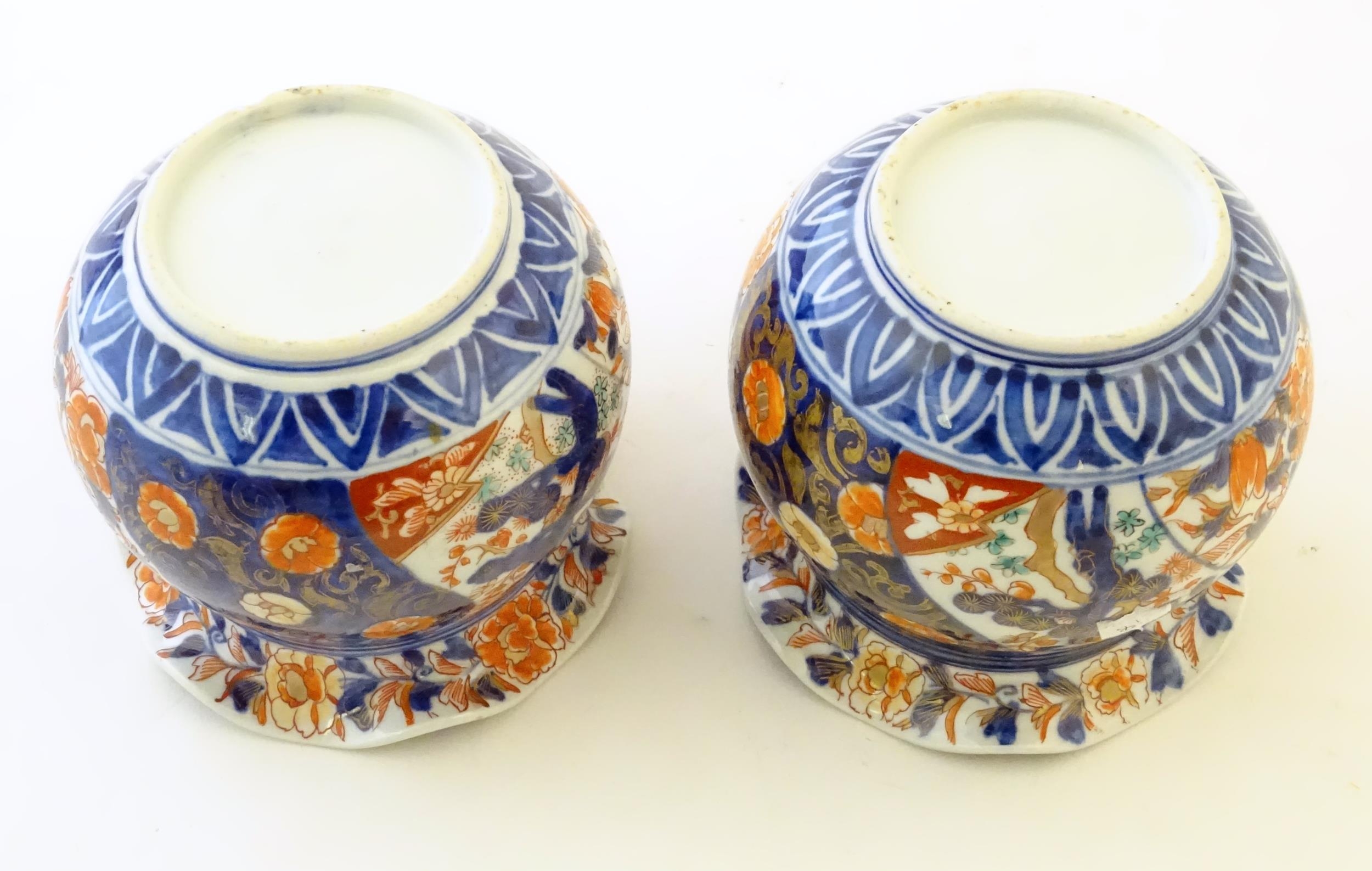 Two Oriental vases of bulbous form with flared rims decorated in the Imari palette with flowers - Image 6 of 8