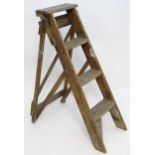 An early to mid 20thC wooden shop step ladder, latticed and folding, with metal plaque marked ' C