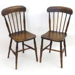 A pair of late 19thC Windsor chairs with shaped top rails and spindle backs above elm seats and