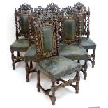A set of six carved early 20thC dining chairs with carved mask cresting rails and barley twist