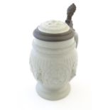 A Villeroy & Boch stoneware stein with moulded foliate decoration. Marked under. Approx. 7" high