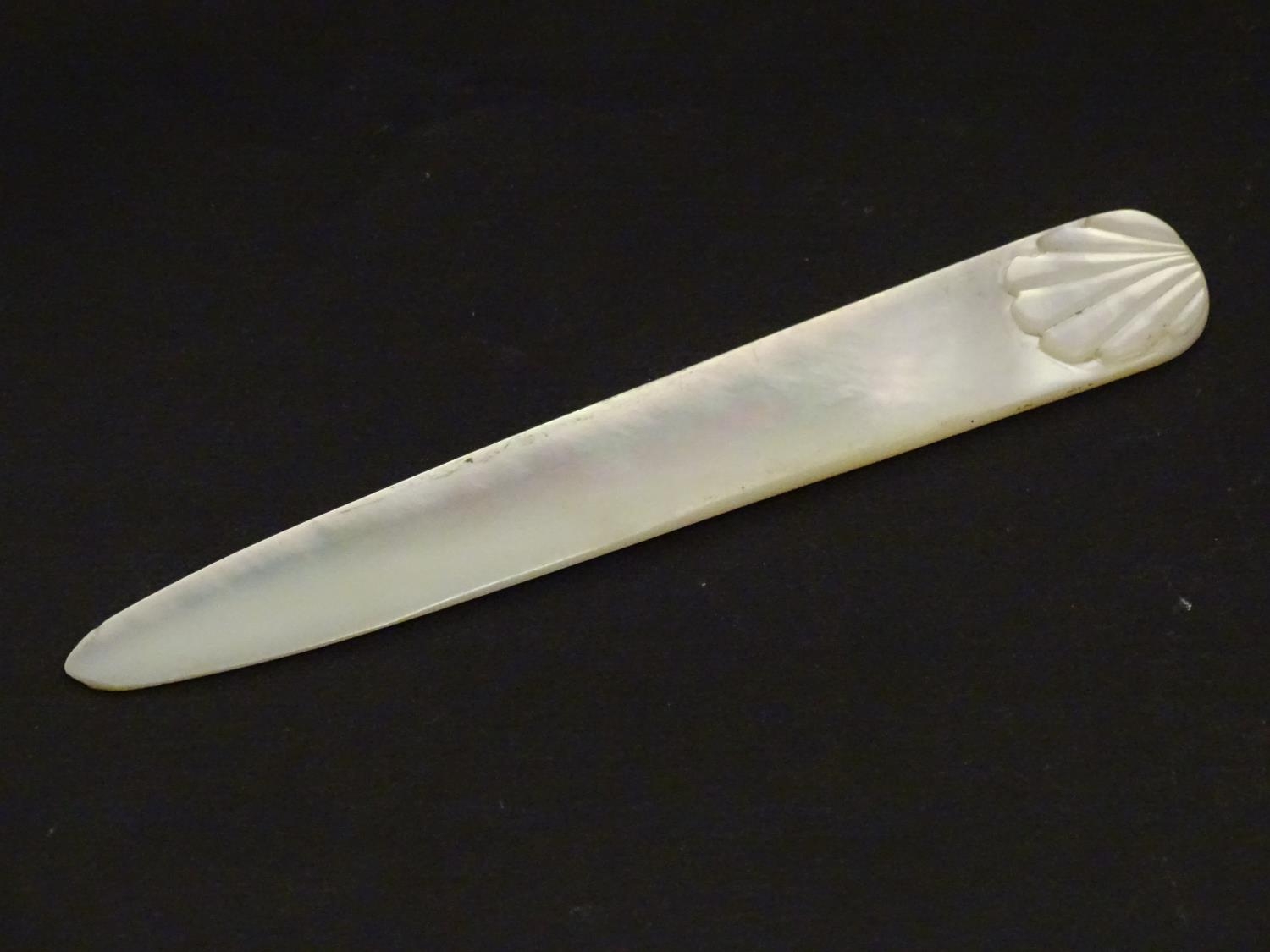 An early 20thC mother of pearl letter opener with shell detail. Approx. 4 1/4" Please Note - we do - Image 2 of 8