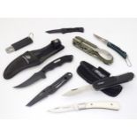 A collection of pocket knives, comprising a Winchester fixed-blade skinning knife with sheath, a
