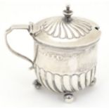 A Victorian silver mustard pot with fluted detail and blue glass lines, hallmarked Birmingham