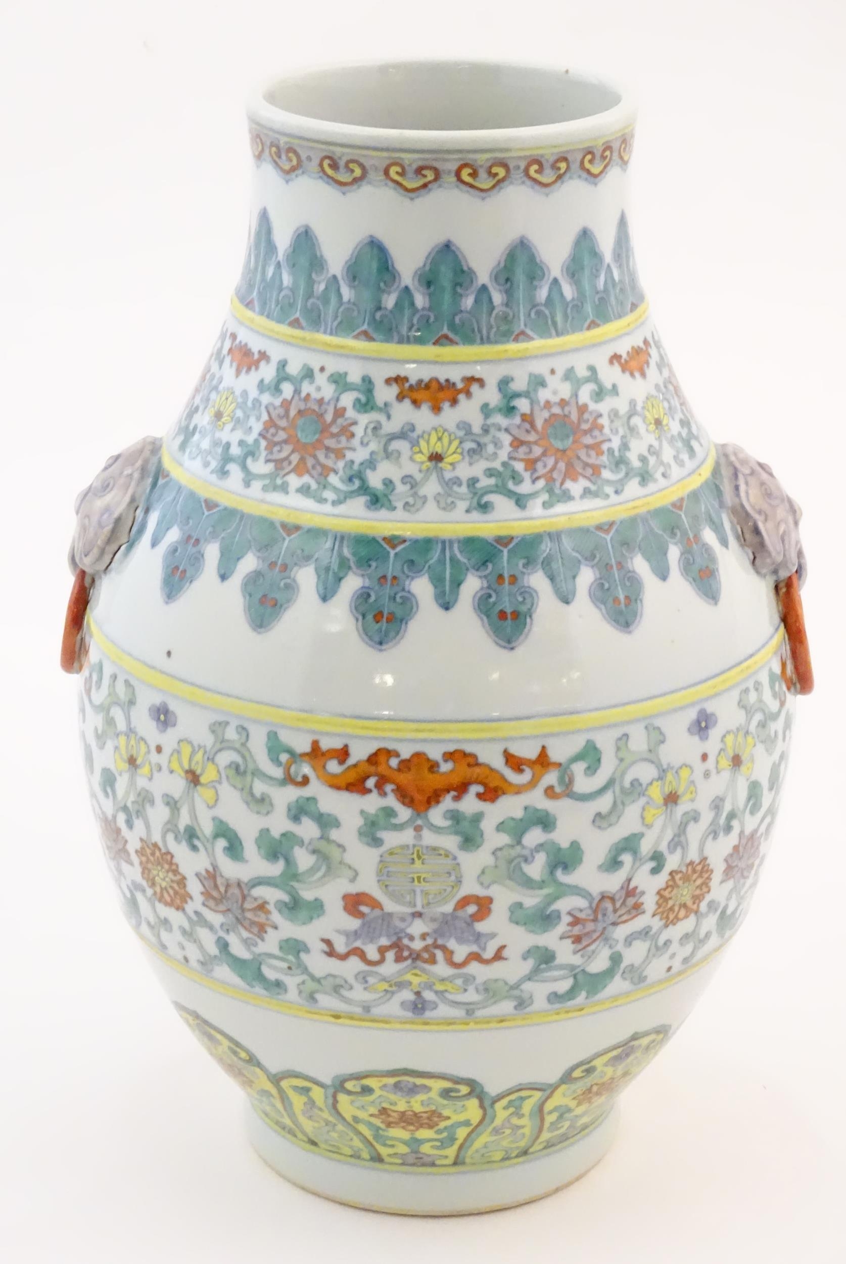 A Chinese famille verte vase with a bulbous body with twin ring mask handles, decorated with - Image 5 of 7