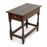 An early 20thC oak side table with a rectangular moulded top above a single long drawer and four