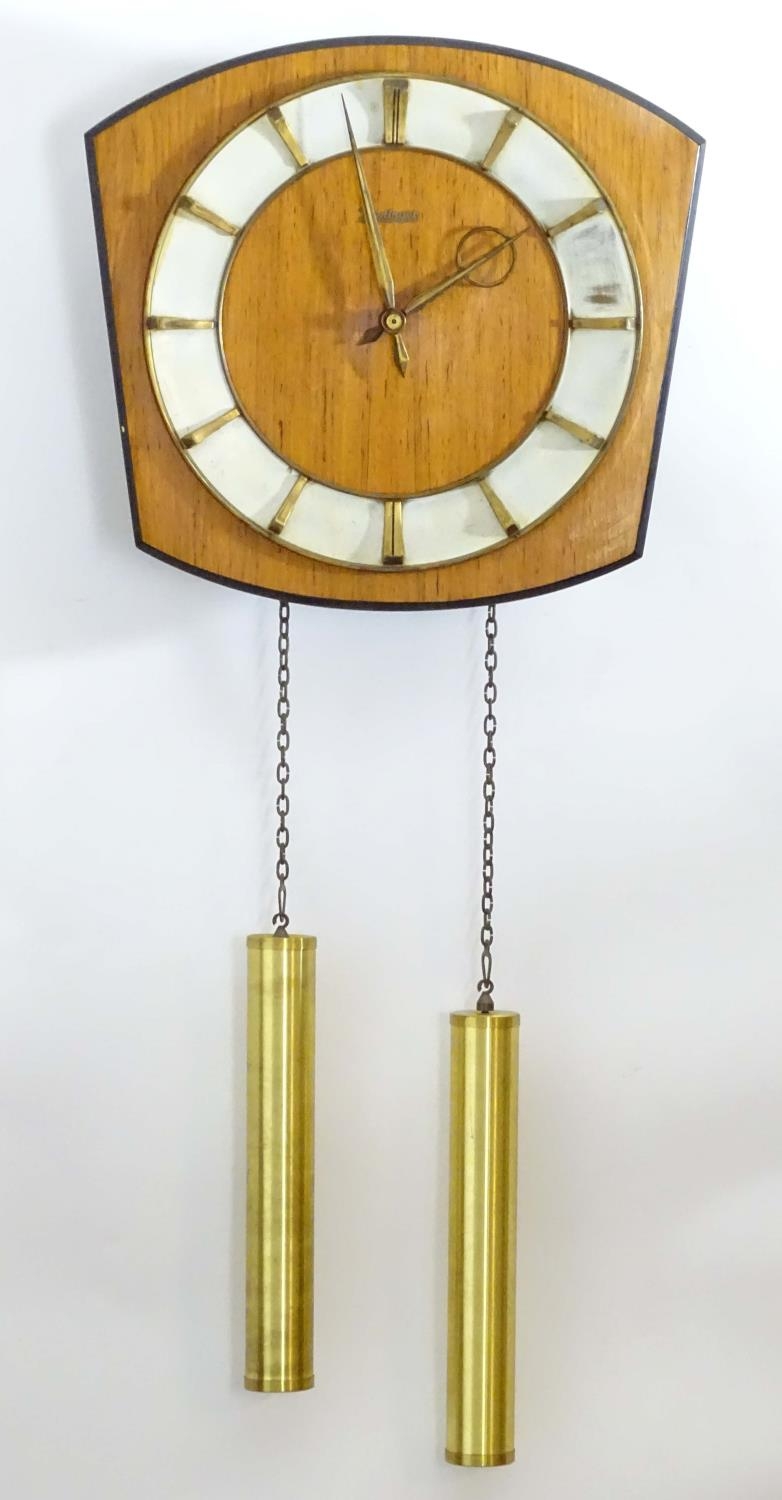 A retro Kieninger teak wall clock with two weights. 12" wide Please Note - we do not make